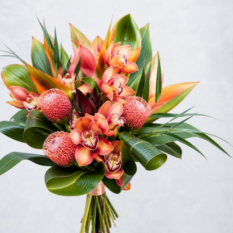 Coral orchid and protea statement bouquet